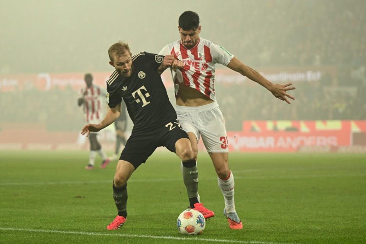 Bayern Munich's Austrian midfielder #27 Konrad Laimer (L) and  FC Cologne's Turkish defender #39 Cenk Ozkacar vie for the ball during the German first division Bundesliga football match between FC Cologne and FC Bayern Munich in Cologne, western Germany on January 14, 2026.  INA FASSBENDER / AFP