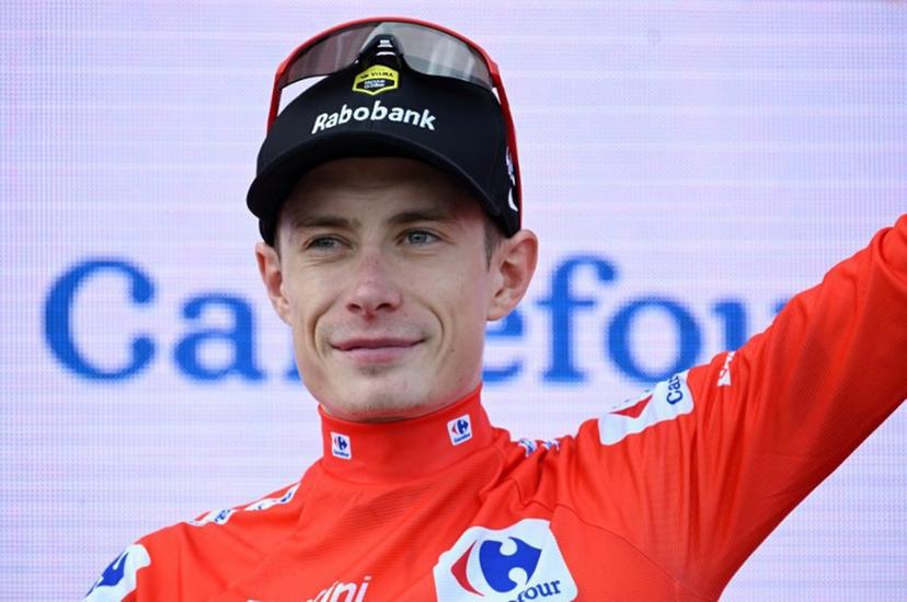 Overall leader of the Team Visma-Lease a Bike, Danish rider Jonas Vingegaard wearing the red jersey celebrates on the podium after the 15th stage of the Vuelta a Espana cycling tour, a 167 km race between A Veiga/Vegaredo and Monforte de Lemos, on September 7, 2025.    Miguel RIOPA / AFP