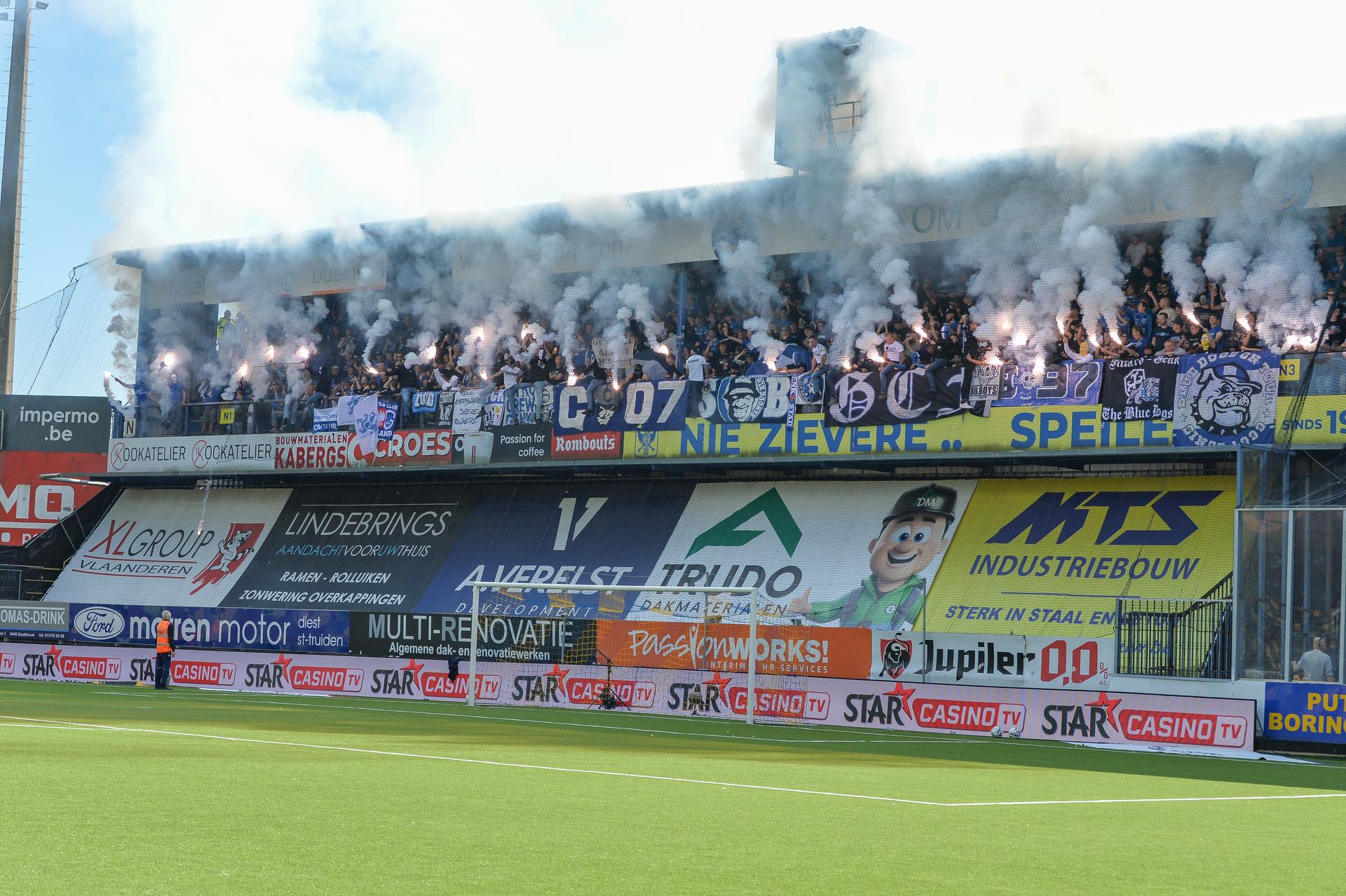 Supporters with fireworks and smoke bombs pictured during a soccer match between Sint-Truidense V.V. and KRC Genk, Sunday 28 September 2025 in Sint-Truiden, on day 9 of the 2025-2026 'Jupiler Pro League' first division of the Belgian championship. BELGA PHOTO JILL DELSAUX
