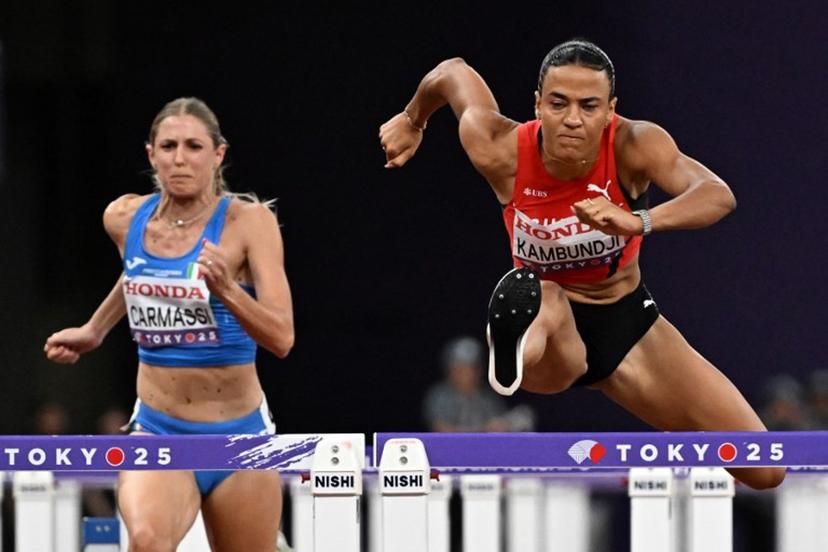 Italy's Giada Carmassi and Switzerland's Ditaji Kambundji compete in the women's 100m hurdles semi-final during the World Athletics Championships in Tokyo on September 15, 2025.  Jewel SAMAD / AFP