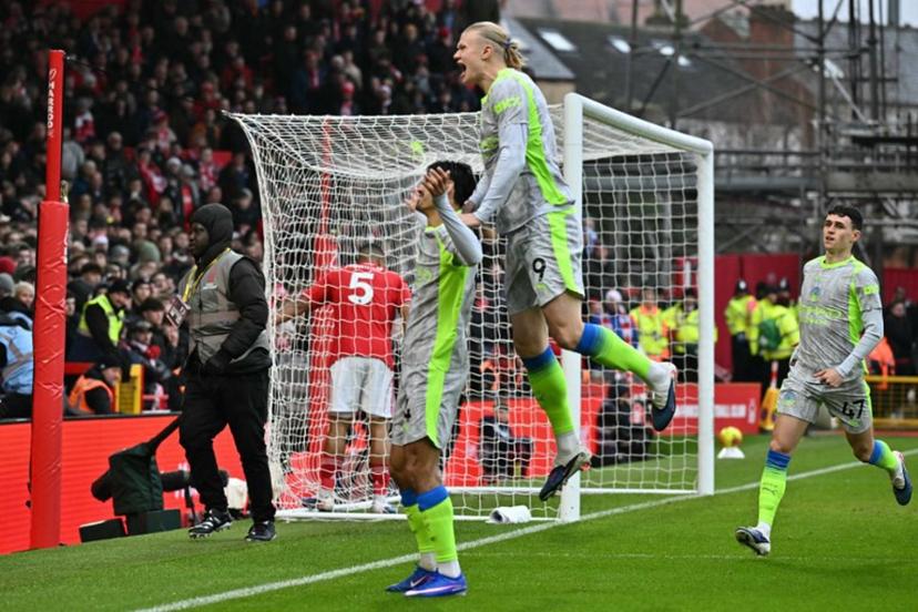 Manchester City's Dutch midfielder #04 Tijjani Reijnders (L) celebrates with teammates after scoring the opening goal of the English Premier League football match between Nottingham Forest and Manchester City at The City Ground in Nottingham, central England, on December 27, 2025.  Ben STANSALL / AFP