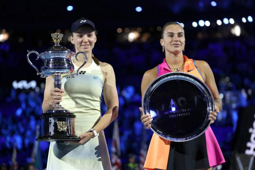 Kazakhstan's Elena Rybakina (L), the women's singles champion, and runner-up Aryna Sabalenka of Belarus pose for photos on the podium after the Australian Open women's final on Day 14 of the tennis tournament in Melbourne on January 31, 2026.  Martin KEEP / AFP