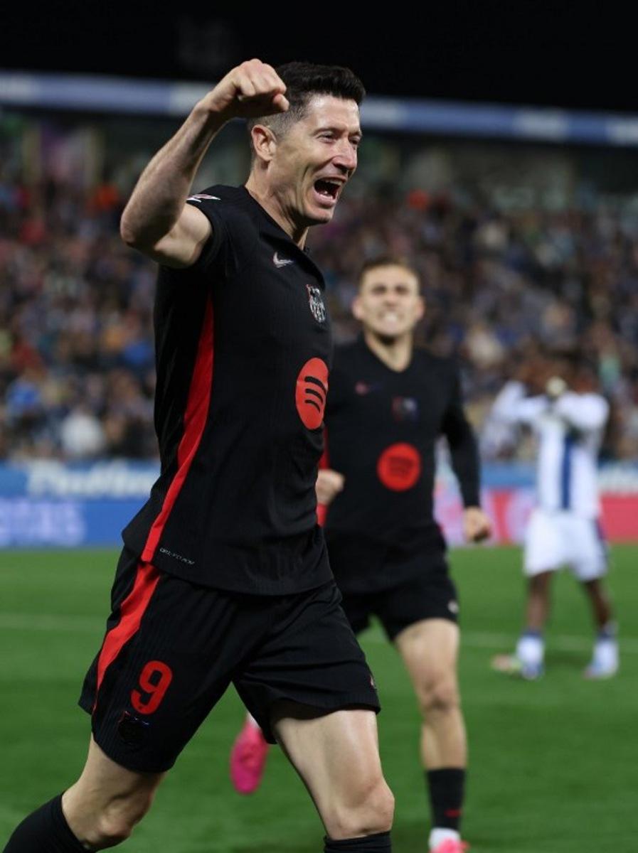 Barcelona's Polish forward #09 Robert Lewandowski celebrates after Leganes' Spanish defender #03 Jorge Saenz scored an own goal during the Spanish league football match between Club Deportivo Leganes SAD and FC Barcelona at the Estadio Municipal Butarque in Leganes, near Madrid, on April 12, 2025.  Thomas COEX / AFP