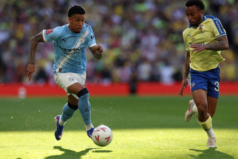 Manchester City's Brazilian midfielder #26 Savinho (L) runs at Southampton's Brazilian defender #34 Welington (R) during the English FA Cup semi final football match between Manchester City and Southampton at Wembley stadium in London, on April 25, 2026.  Adrian Dennis / AFP