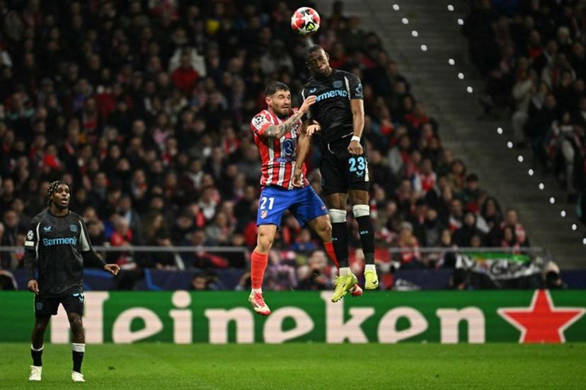 Atletico Madrid's Spanish defender #21 Javi Galan and Bayer Leverkusen's French defender #23 Nordi Mukiele vie for a header during the UEFA Champions League, league phase football match between Club Atletico de Madrid and Bayer Leverkusen at the Metropolitano stadium in Madrid on January 21, 2025.  JAVIER SORIANO / AFP
