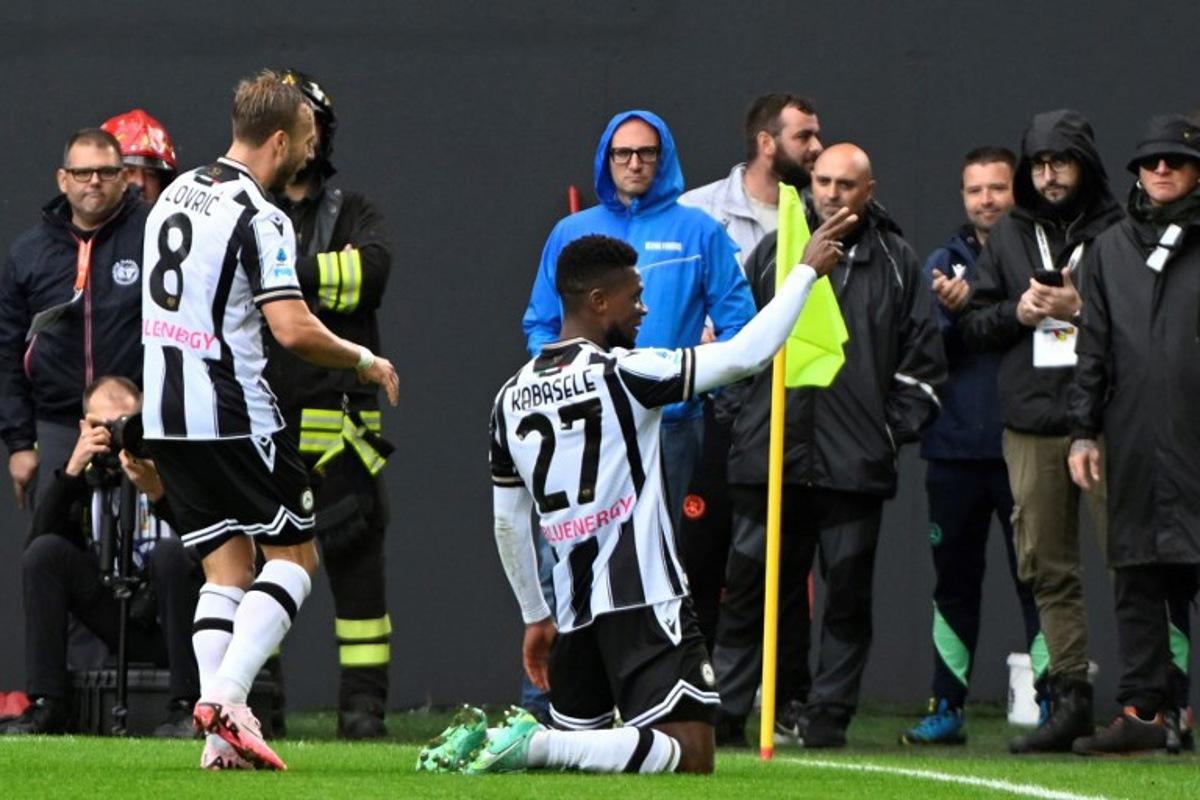 Udinese's Belgian defender #27 Christian Kabasele (R) celebrates with teammate Inter Milan's Austrian forward #08 Marko Arnautovic after scoring a goal during the Italian Serie A football match between Udinese and Inter Milan at the Bluenergy Friuli Stadium, in Udine on September 28, 2024.  ANDREA PATTARO / AFP