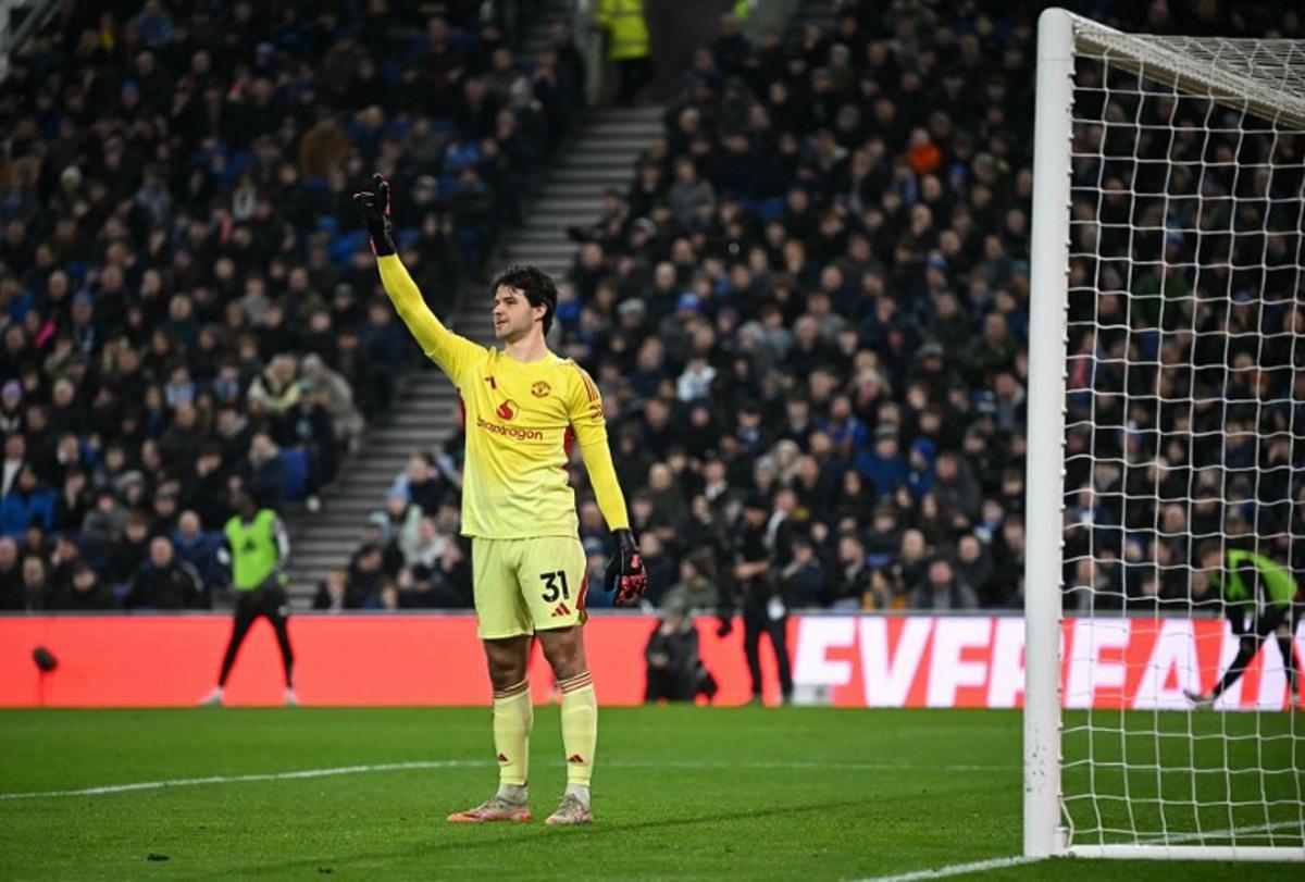 Manchester United's Belgian goalkeeper #31 Senne Lammens gestures to teammates during the English Premier League football match between Everton and Manchester United at the Hill Dickinson Stadium in Liverpool, north west England on February 23, 2026.  Paul ELLIS / AFP
