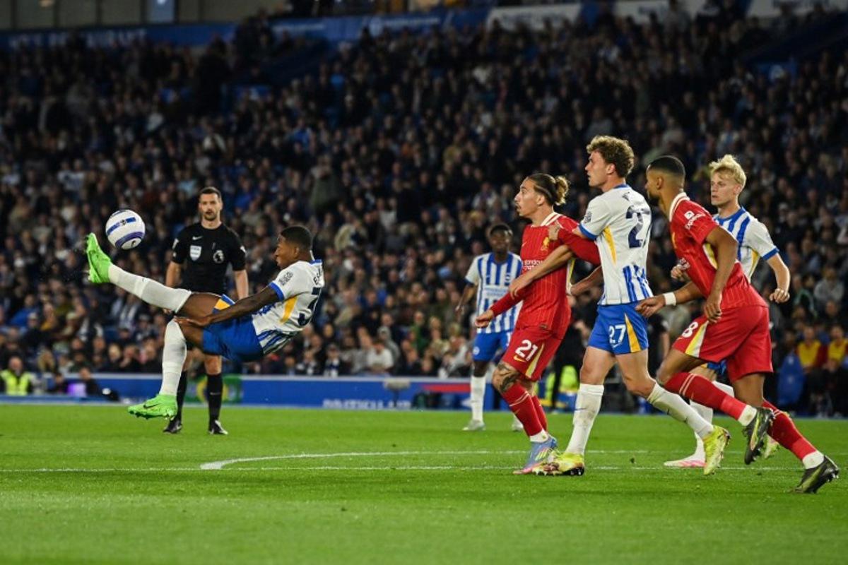 Brighton's Ecuadorian defender #30 Pervis Estupinan shoots the ball during the English Premier League football match between Brighton and Hove Albion and Liverpool at the American Express Community Stadium in Brighton, southern England on May 19, 2025.  Glyn KIRK / AFP