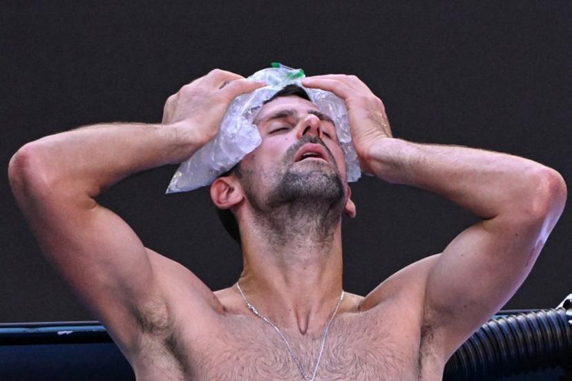 Serbia's Novak Djokovic uses ice packs on his head between the games against USA's Taylor Fritz during their men's singles quarter-final match on day 10 of the Australian Open tennis tournament in Melbourne on January 23, 2024.  WILLIAM WEST / AFP