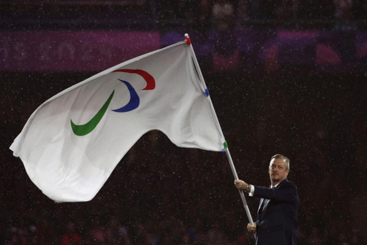 President of the International Paralympic Committee (IPC) Andrew Parsons waves the Paralympics flag during the Paris 2024 Paralympic Games Closing Ceremony at the Stade de France, in Saint-Denis, in the outskirts of Paris, on September 8, 2024.  Thibaud Moritz / AFP