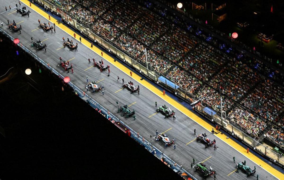 Drivers prepare to take the start of the Formula One Singapore Grand Prix night race at the Marina Bay Street Circuit in Singapore on October 5, 2025.  ROSLAN RAHMAN / AFP