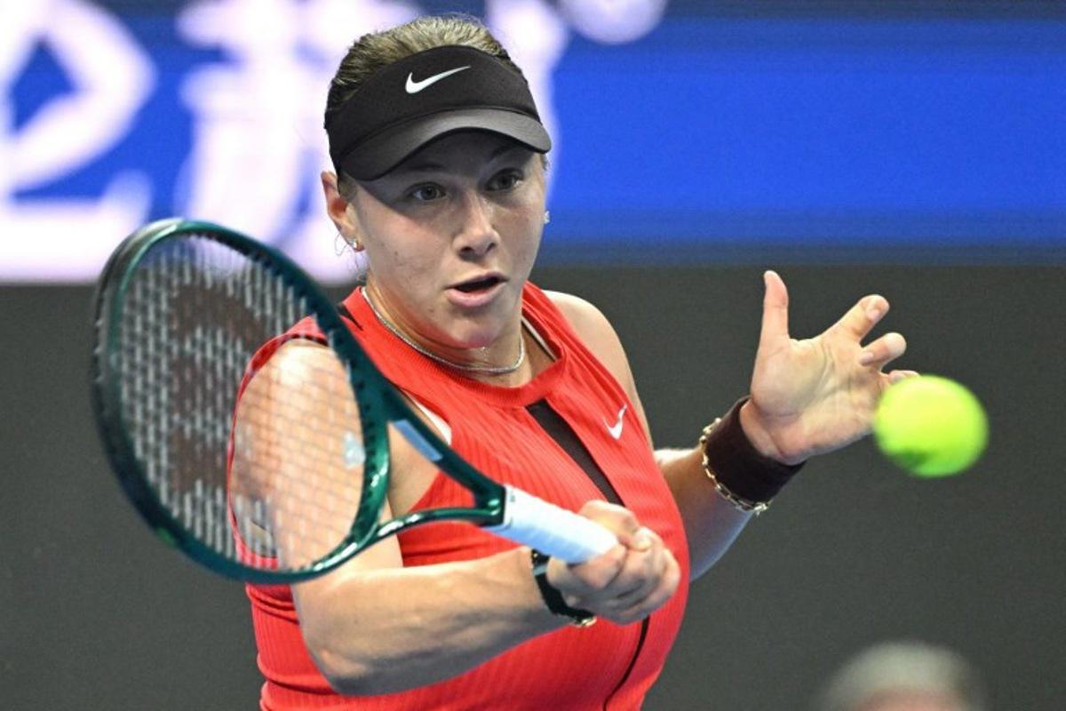 USA's Amanda Anisimova hits a return to Czech Republic's Linda Noskova during the women's singles final at the China Open tennis tournament in Beijing on October 5, 2025.  Greg Baker / AFP