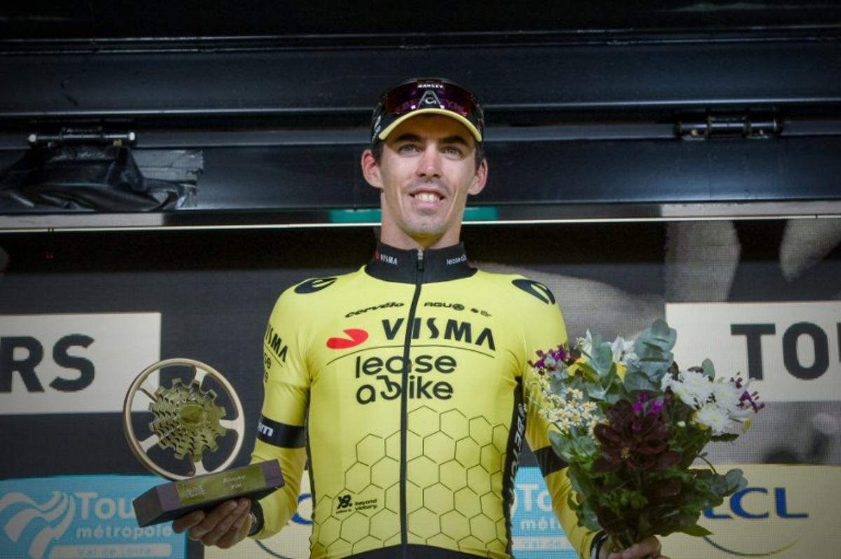 French rider of team Visma Lease A Bike Christophe Laporte celebrates on the podium after he won the 118th edition of the 213,9 km Paris-Tours one day cycling race, in Tours, central France on October 6, 2024.  GUILLAUME SOUVANT / AFP