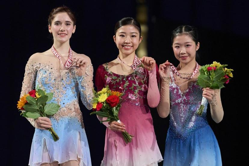 Gold medalist Mone Chiba of Japan (C) poses with silver medalist Isabeau Levito of the United States (L) and Ami Nakai of Japan during the victory ceremony for the women's competition during the ISU Grand Prix of Figure Skating 2025 Skate Canada International at the SaskTel Centre in Saskatoon, Saskatchewan, Canada on November 1, 2025.  Geoff Robins / AFP