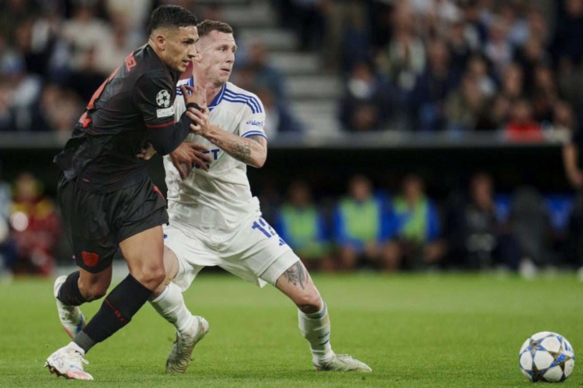 FC Copenhagen's Danish midfielder #12 Lukas Lerager (R) and Bayer Leverkusen's Argentinian midfielder #06 Ezequiel Fernandez vie for the ball during the UEFA Champions League league phase day 1 football match between FC Copenhagen and Bayer Leverkusen in Copenhagen, Denmark, on September 18, 2025.  Liselotte Sabroe / Ritzau Scanpix / AFP