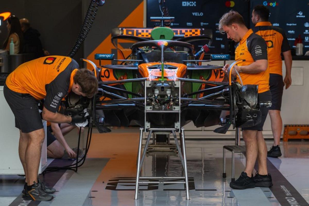 Mechanics work on the car of McLaren's Australian driver Oscar Piastri at the Lusail International Circuit ahead of the Formula One Qatar Grand Prix in Lusail on November 27, 2025.  Andrej ISAKOVIC / AFP