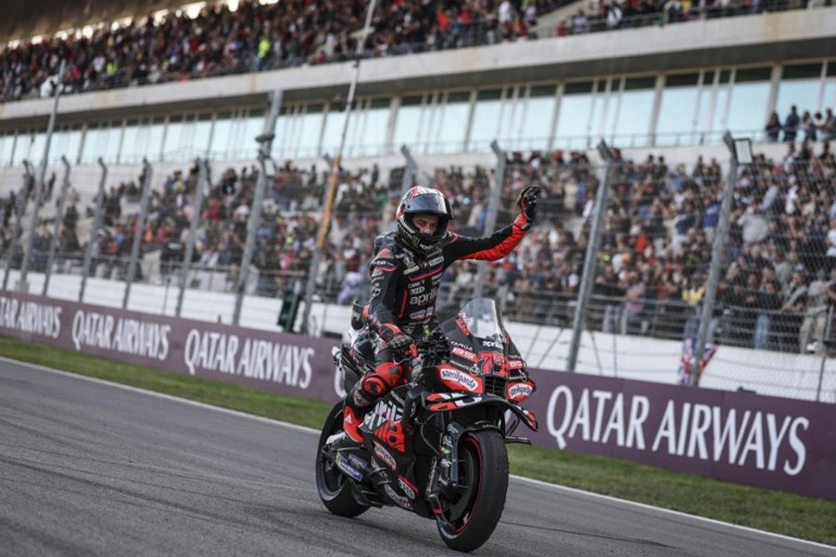 Aprilia Racing team's Italian MotoGP rider Marco Bezzecchi celebrates his third place in the MotoGP sprint race of the Portuguese Grand Prix at the Algarve International Circuit in Portimao on November 8, 2025.  PATRICIA DE MELO MOREIRA / AFP
