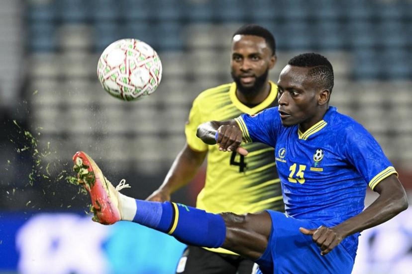 Uganda's defender #04 Kenneth Semakula and Tanzania's defender #15 Mohamed Hussein vie during the Africa Cup of Nations (CAN) Group C football match between Uganda and Tanzania at Al Medina Stadium in Rabat on December 27, 2025.   SEBASTIEN BOZON / AFP