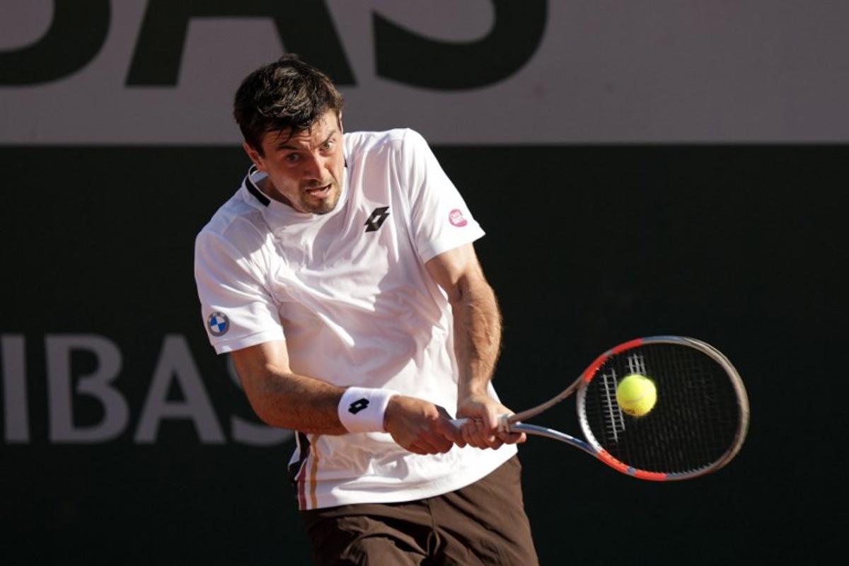 Austria's Sebastian Ofner plays a backhand return to Italy's Luciano Darderi during their men's singles match on day 3 of the French Open tennis tournament at the Roland-Garros Complex in Paris on May 26, 2026.  Dimitar DILKOFF / AFP