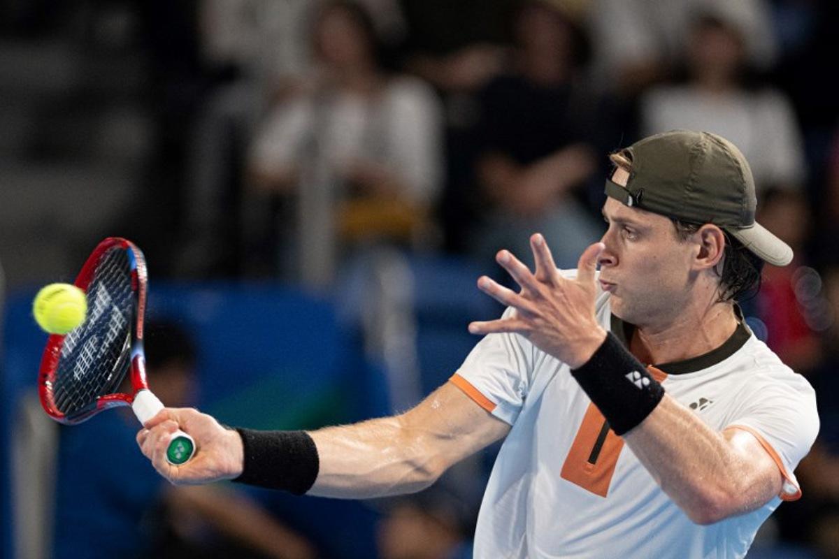 Belgium's Zizou Bergs hits a return against Spain's Carlos Alcaraz during their men's singles match at the ATP Japan Open tennis tournament in Tokyo on September 27, 2025.  Philip FONG / AFP