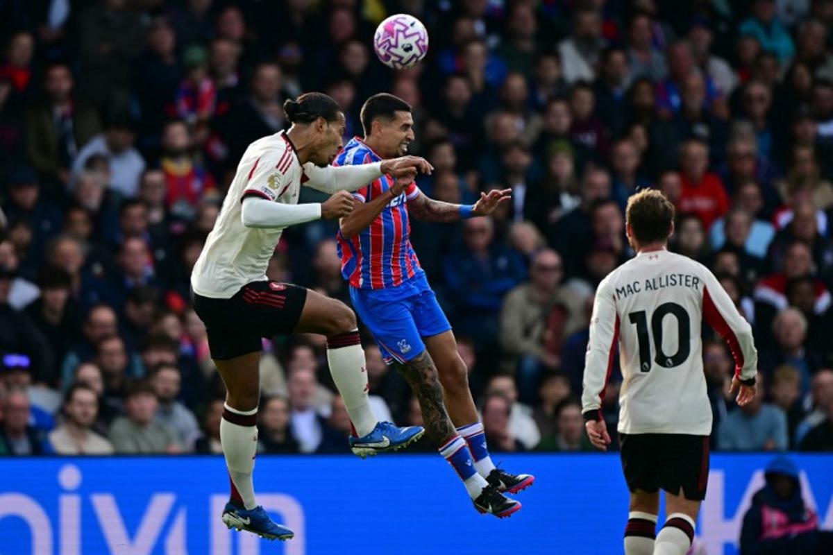 Liverpool's Dutch defender #04 Virgil van Dijk (L) vies with Crystal Palace's Colombian defender #02 Daniel Munoz (C) during the English Premier League football match between Crystal Palace and Liverpool at Selhurst Park in south London on September 27, 2025.  Ben STANSALL / AFP
