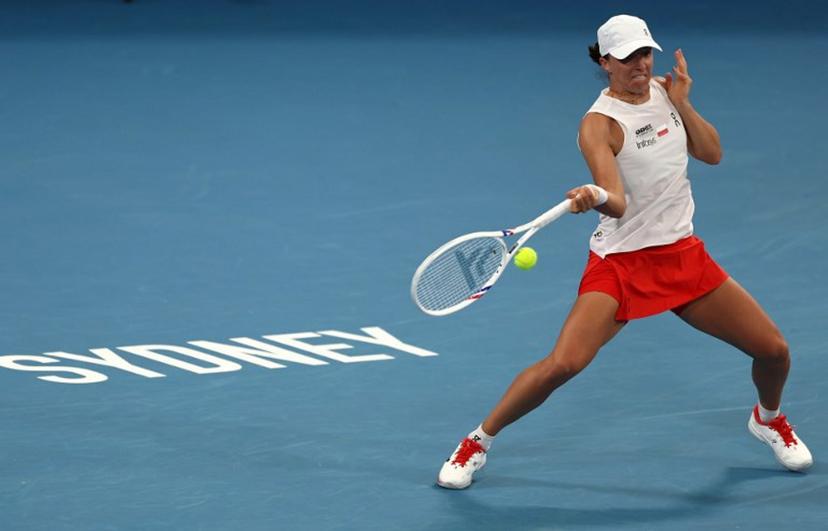 Poland's Iga Swiatek hits a return to Australia's Maya Joint during their women's singles quarter-final match at the United Cup at Ken Rosewall Arena in Sydney on January 9, 2026.  Izhar Khan / AFP