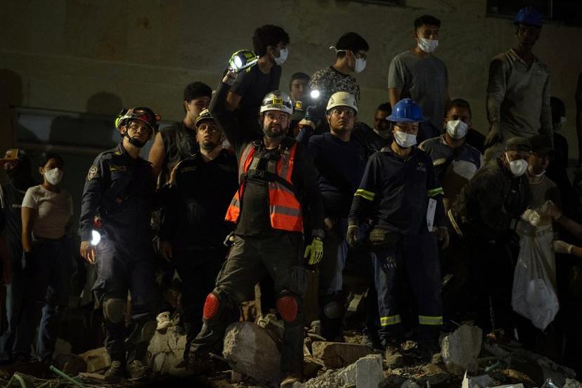 Rescuers look for survivors amid the rubble of a collapsed building after an earthquake in Pereira, Colombia, on August 10, 2026. A magnitude 7.4 earthquake struck Colombia on August 10, 2026, and killed at least 111 people, damaged more than 1,500 buildings, and left an unknown number of people buried under rubble. The government declared a state of emergency to attend to the quake that shook several cities across the coffee-producing region, the Pacific coast, and neighboring Latin American countries, sending terrified residents racing into the street. Luis ACOSTA / AFP