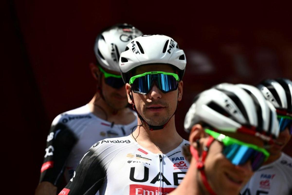 Team UAE's Portuguese rider Joao Almeida prepares to take the start of the third stage of the Vuelta a Espana, a 134 km race between San Maurizio Canavese and Ceres, in Italy's Piemonte region, on August 25, 2025.    Marco BERTORELLO / AFP
