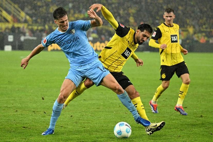 Bochum's German defender #14 Tim Oermann (L) and Dortmund's German midfielder #23 Emre Can vie for the ball during the German first division Bundesliga football match between BVB Borussia Dortmund and VfL Bochum in Dortmund, western Germany on September 27, 2024.  INA FASSBENDER / AFP