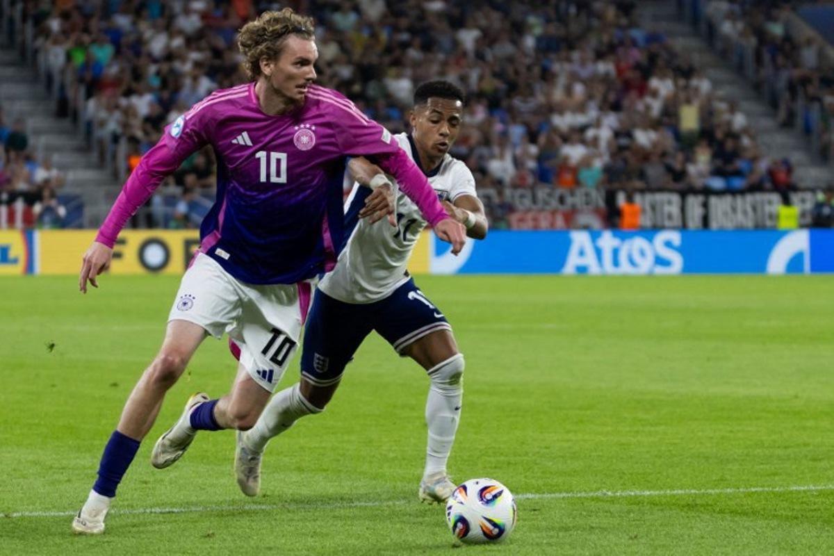 Germany's forward #10 Nick Woltemade (L) and England's forward #11 Omari Hutchinson vie for the ball during the UEFA U21 European Championship final football match between England and Germany in Bratislava, Slovakia on June 28, 2025.  TOMAS BENEDIKOVIC / AFP