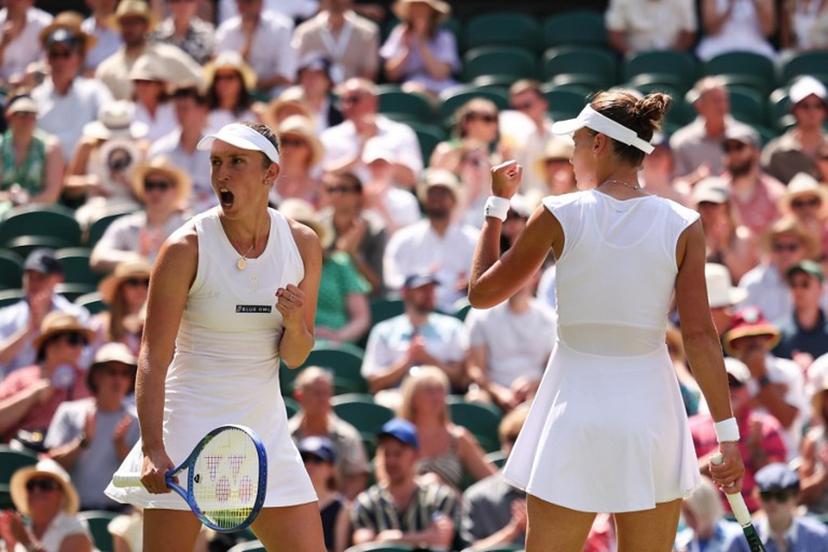 Russia's Veronika Kudermetova (R) and Belgium's Elise Mertens react after a point as they play against Taiwan's Hsieh Su-wei and Latvia's Jelena Ostapenko during their women's doubles final tennis match on the fourteenth day of the 2025 Wimbledon Championships at The All England Lawn Tennis and Croquet Club in Wimbledon, southwest London, on July 13, 2025.  HENRY NICHOLLS / AFP