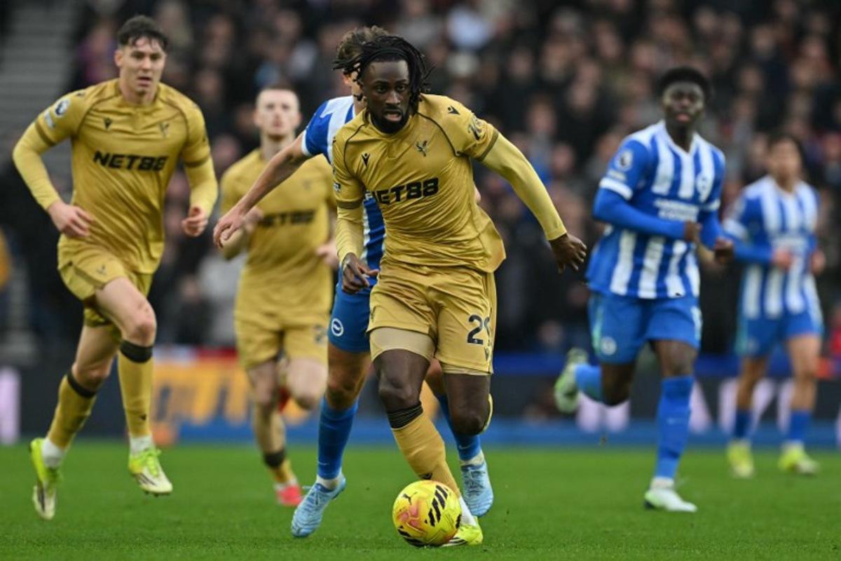 Crystal Palace's Ivorian striker #29 Evann Guessand runs with the ball during the English Premier League football match between Brighton and Hove Albion and Crystal Palace at the American Express Community Stadium in Brighton, southern England on February 8, 2026.  Glyn KIRK / AFP