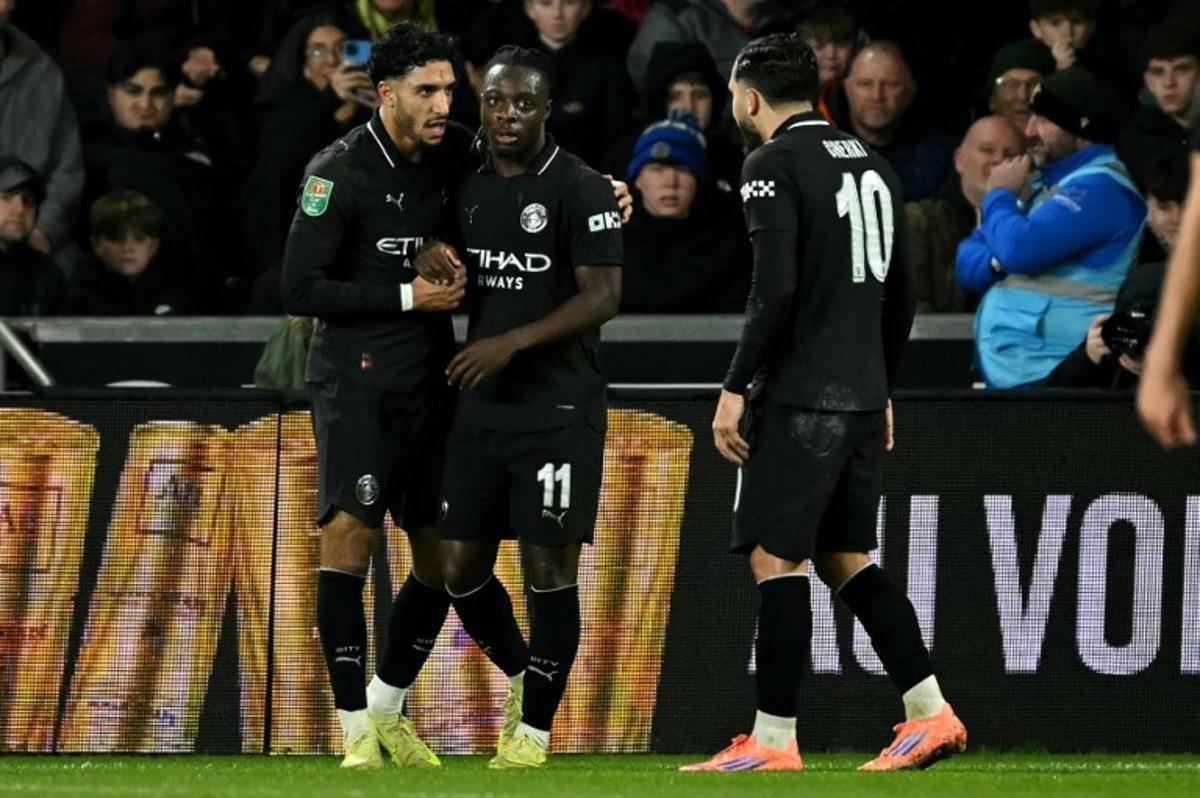 Manchester City's Egyptian striker #07 Omar Marmoush (L) celebrates scoring the team's second goal during the English League Cup fourth round football match between Swansea City and Manchester City at the Swansea.com stadium, in south Wales on October 29, 2025.  JUSTIN TALLIS / AFP