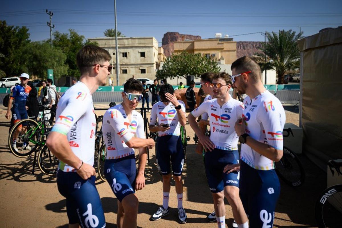 Totalenergies team members waits prior to the start of the first stage of the AlUla Tour cycling race from the Al-Manshiyah Train station to the Al-Manshiyah Train Station, a 142.7 kilometres ride, in Alula, northwestern Saudi Arabia on January 28, 2025.  Loic VENANCE / AFP