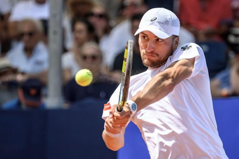 Belgium's Raphael Collignon returns the ball to Greece's Stefanos Tsitsipas during their men's singles final match at the Swiss Open tennis tournament in Gstaad, on July 19, 2026.  Fabrice COFFRINI / AFP