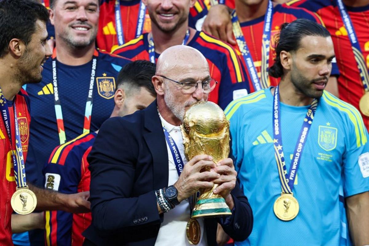 Spain's head coach Luis de la Fuente kisses the trophy after winning the 2026 World Cup football tournament final match between Spain and Argentina at the New York/New Jersey Stadium in East Rutherford on July 19, 2026.   FRANCK FIFE / AFP