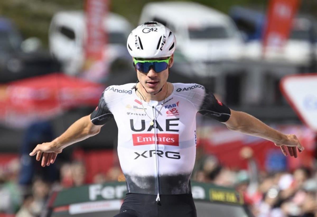 Team UAE's Spanish rider Juan Ayuso gestures as he celebrates crossing first the finish line during the seventh stage of the Vuelta a Espana, a 187 km race between Andorra la Vella and Cerler, on August 29, 2025.    Josep LAGO / AFP