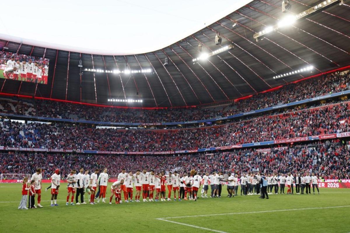 FC Bayern Munich's team celebrates with fans after winning the German first division Bundesliga football match between FC Bayern Munich and VfB Stuttgart in Munich, southern Germany, on April 19, 2026. Harry Kane scored his 32nd goal of the campaign as Bayern Munich cruised to a 4-2 home win over Stuttgart and claim a record-extending 35th Bundesliga title.  Alexandra BEIER / AFP