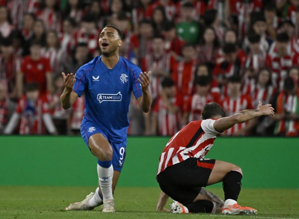 Rangers' Belgian-born Nigerian striker #09 Cyriel Dessers gestures next to Athletic Bilbao's Spanish defender #05 Yerai Alvarez during the UEFA Europa League quarter final second leg football match between Athletic Club Bilbao and Glasgow Rangers, at the San Mames stadium in Bilbao on April 17, 2025.  ANDER GILLENEA / AFP