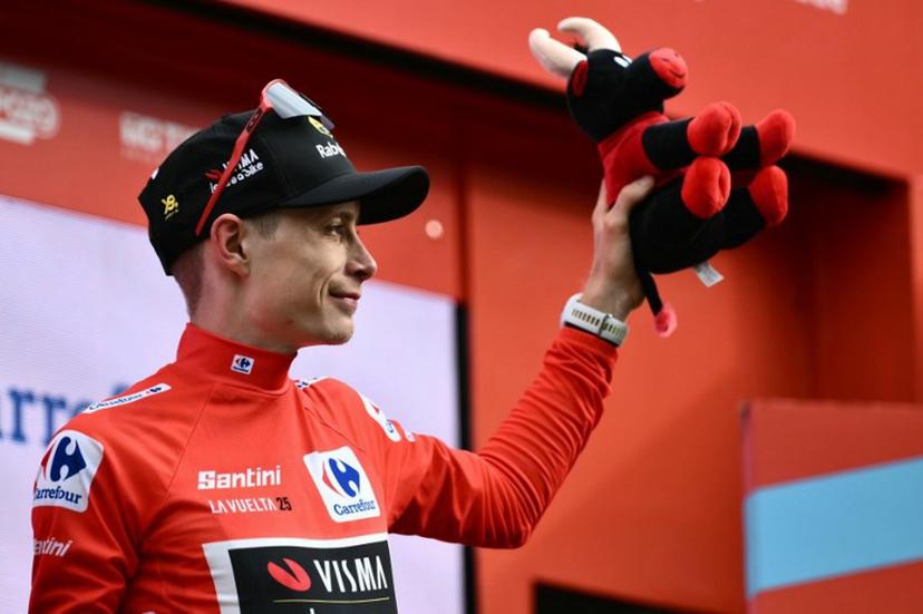 Team Visma-Lease a bike's Danish rider Jonas Vingegaard celebrates on the podium wearing the overall leader's red jersey after the third stage of the Vuelta a Espana, a 134 km race between San Maurizio Canavese and Ceres, in Italy's Piemonte region, on August 25, 2025.    Marco BERTORELLO / AFP