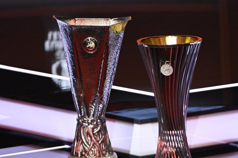 This photograph shows the competitions trophies displayed on set ahead of the draw ceremony for the group stage of the 2025-2026 UEFA Europa League and Conference League tournaments, at the Grimaldi forum in Monaco on August 29, 2025.  Frederic DIDES / AFP
