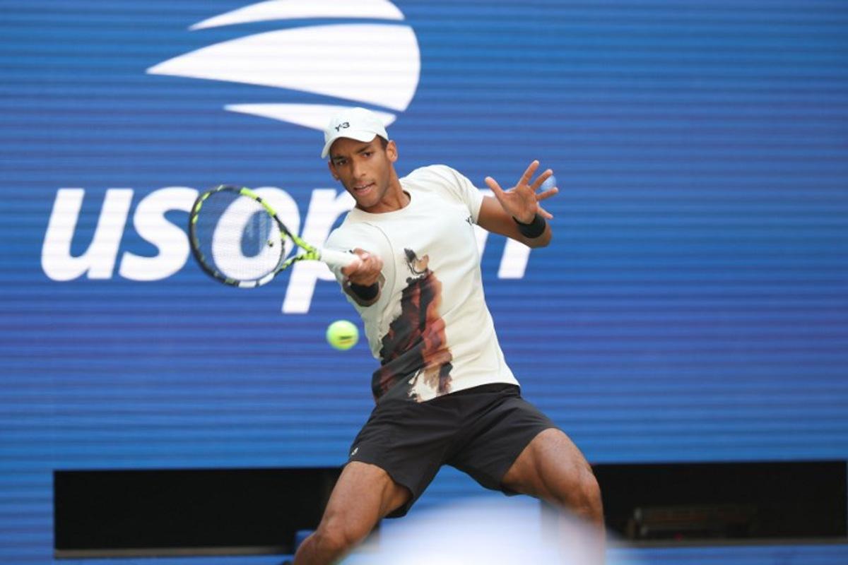 Canada's Felix Auger-Aliassime plays a forehand return to Australia's Alex De Minaur during their men's singles quarterfinal tennis match on day eleven of the US Open tennis tournament at the USTA Billie Jean King National Tennis Center in New York City, on September 3, 2025.  TIMOTHY A. CLARY / AFP