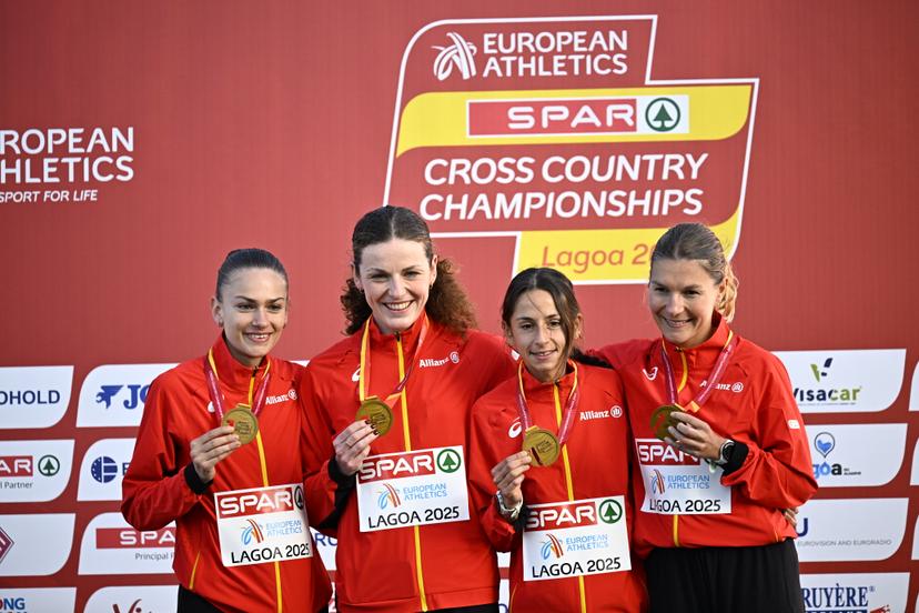 Belgians Jana van Lent, Lisa Rooms, Chloe Herbiet and Victoria Warpy celebrate on the podium after winning the Women Elite race at the 2025 SPAR European Cross Country Championships, in Lagoa, Portugal, Sunday 14 December 2025. BELGA PHOTO JASPER JACOBS