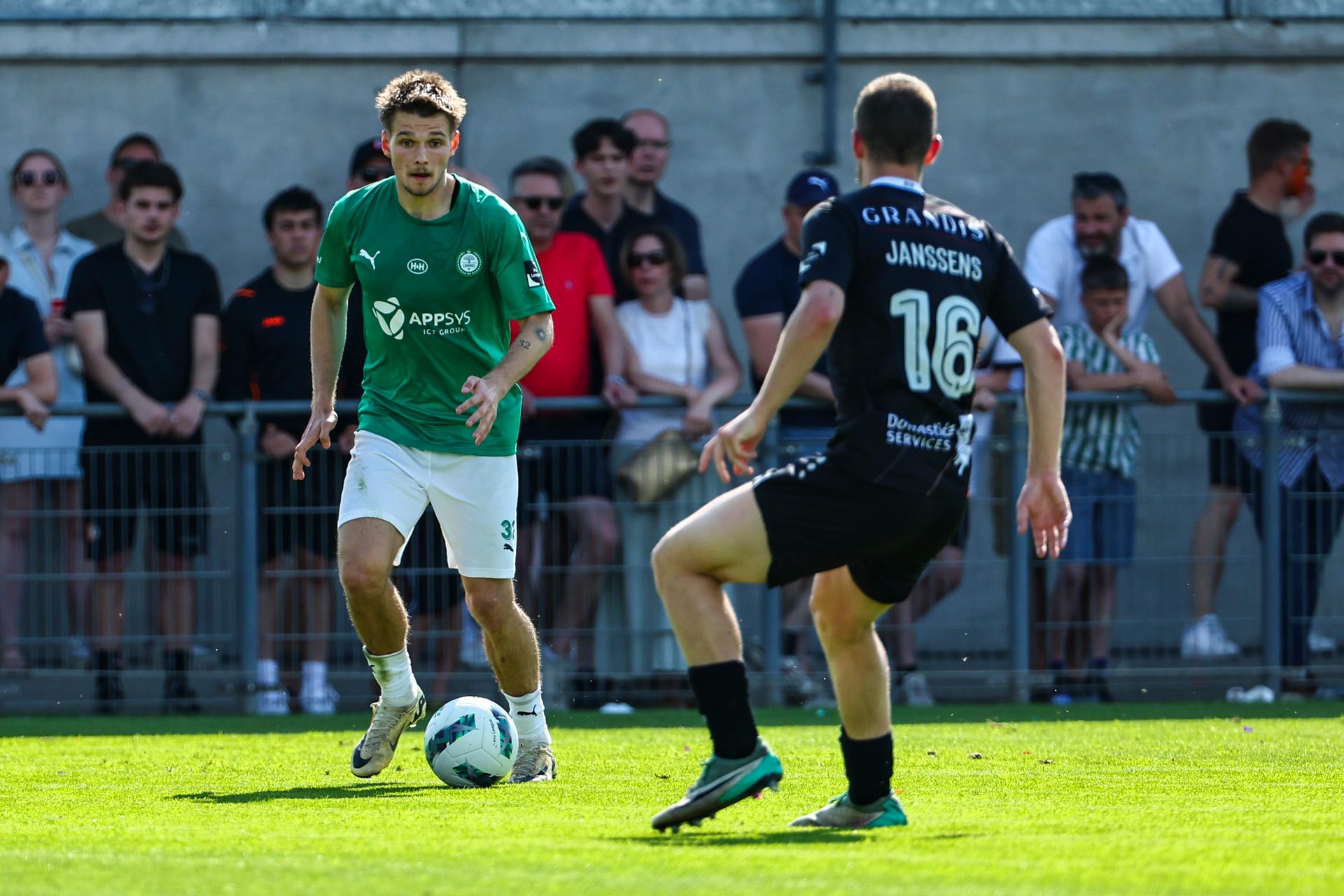 Lommel's Juho Talvitie and Deinze's Christophe Janssens fight for the ball during a soccer match between KMSK Deinze and Lommel SK, Sunday 12 May 2024 in Deinze, the second leg of the semi-final for the promotion at the end of the 2023-2024 'Challenger Pro League' second division of the Belgian championship. BELGA PHOTO DAVID PINTENS