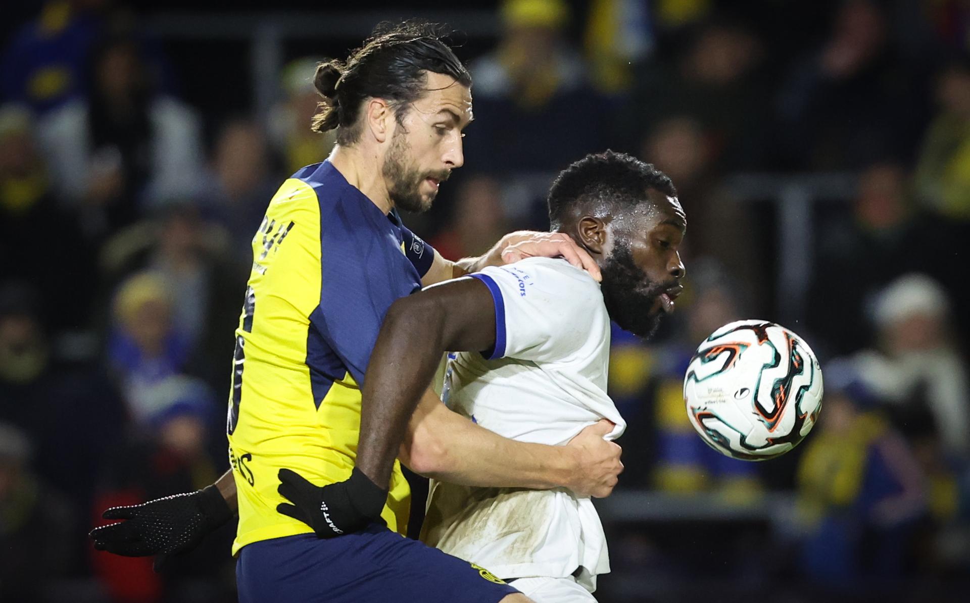Union's Christian Burgess and Gent's Wilfried Kanga fight for the ball during a soccer match between Royale Union Saint-Gilloise and KAA Gent, Saturday 06 December 2025 in Brussels, on day 17 of the 2025-2026 'Jupiler Pro League' first division of the Belgian championship. BELGA PHOTO VIRGINIE LEFOUR