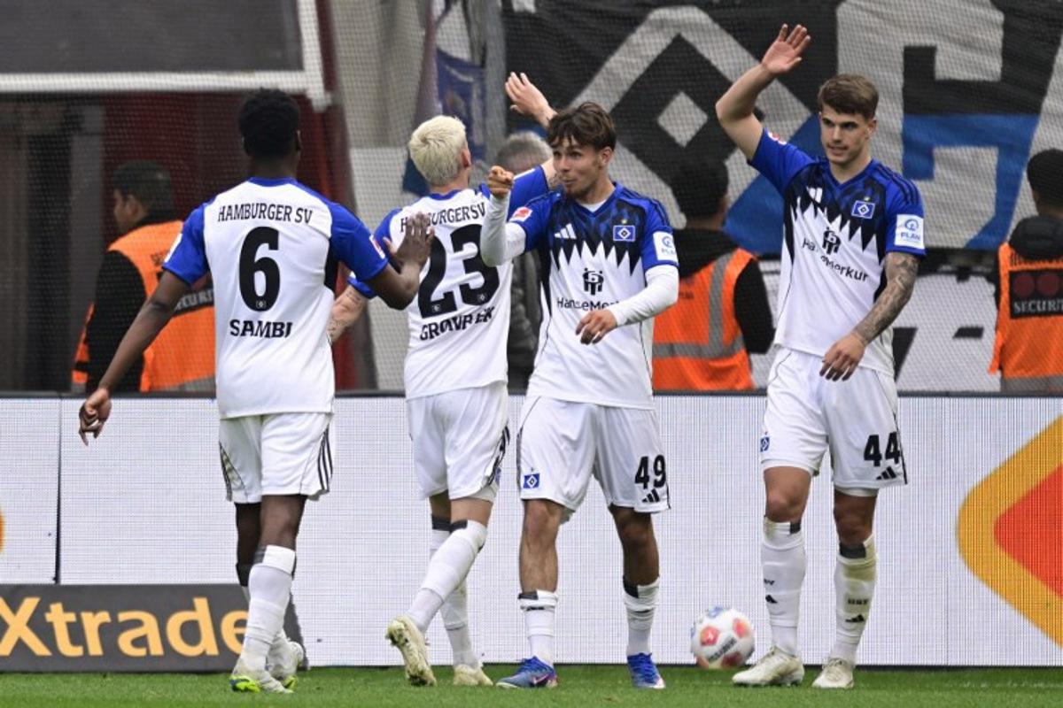 Hamburg's Belgian-Congolese midfielder #06 Albert Sambi Lokonga, Hamburg's Danish midfielder #23 Albert Gronbaek, Hamburg's German forward #49 Otto Stange and Hamburg's Croatian defender #44 Luka Vuskovic celebrate after scoring the opening goal during the German first division Bundesliga football match between Bayer Leverkusen and Hamburger SV (HSV) in Leverkusen, western Germany, on May 16, 2026.  INA FASSBENDER / AFP