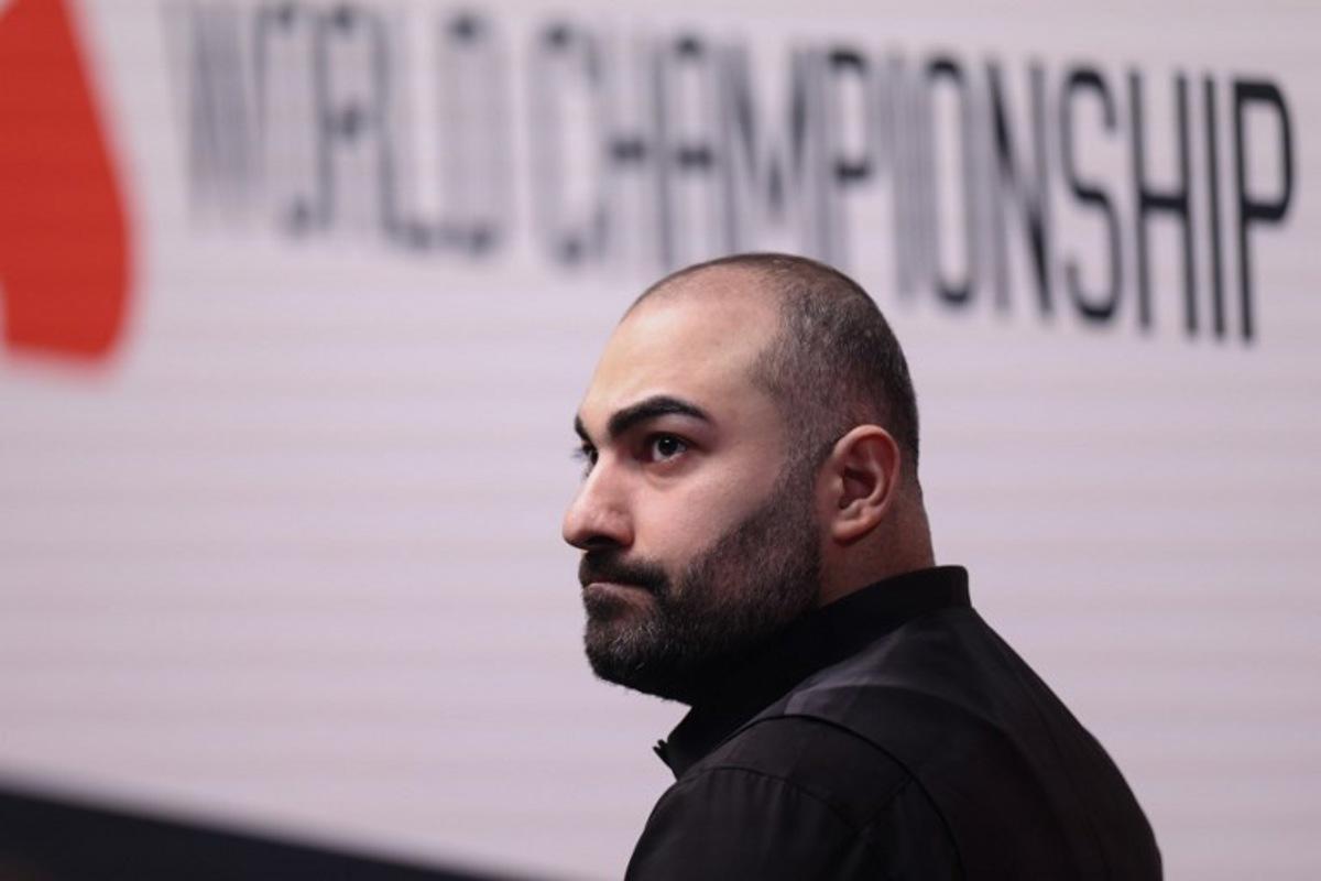 Iran's Hossein Vafaei looks up during his World Snooker Championship Round One match against China's Si Jiahui (not pictured) at The Crucible in Sheffield, northern England on April 22, 2026.  The World Snooker Championship 2025 will take place from April 19 to May 5, 2025. Darren Staples / AFP