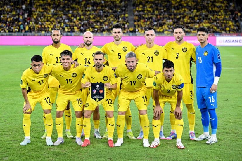 Malaysia's players pose before the start of the AFC Asian Cup qualifier Group F football match between Malaysia and Vietnam at the National Stadium Bukit Jalil in Kuala Lumpur on June 10, 2025.  Mohd RASFAN / AFP