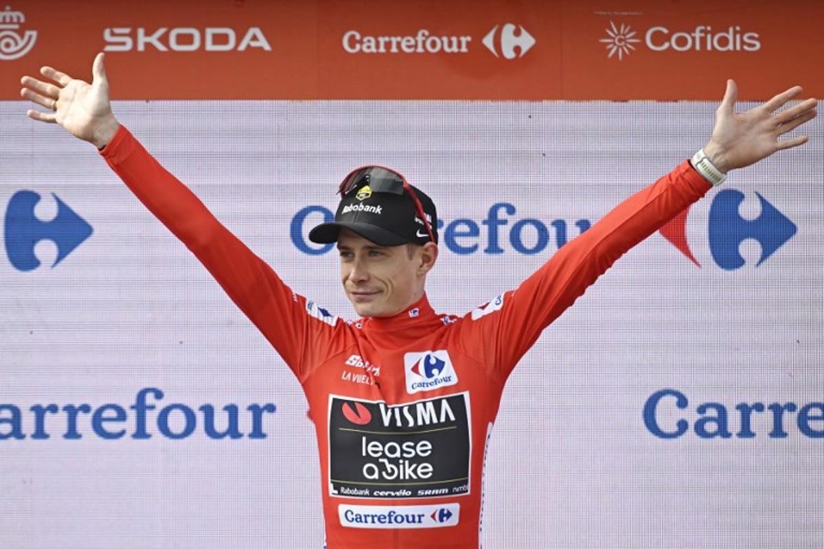 The overall leader Team Visma-Lease a bike's Danish rider Jonas Vingegaard celebrates on the podium wearing the red jersey after the tenth stage of the Vuelta a Espana cycling tour, a 168 km race between Sendaviva Natural Park in Arguedas and El Ferial Larra Belagua in Isaba, on September 2, 2025.    Ander GILLENEA / AFP