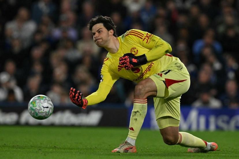 Manchester United's Belgian goalkeeper #31 Senne Lammens rolls the ball out during the English Premier League football match between Chelsea and Manchester United at Stamford Bridge in London on April 18, 2026.  Glyn KIRK / AFP